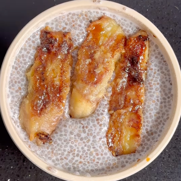 Caramelized banana slices in a speckled ceramic bowl, ready to serve