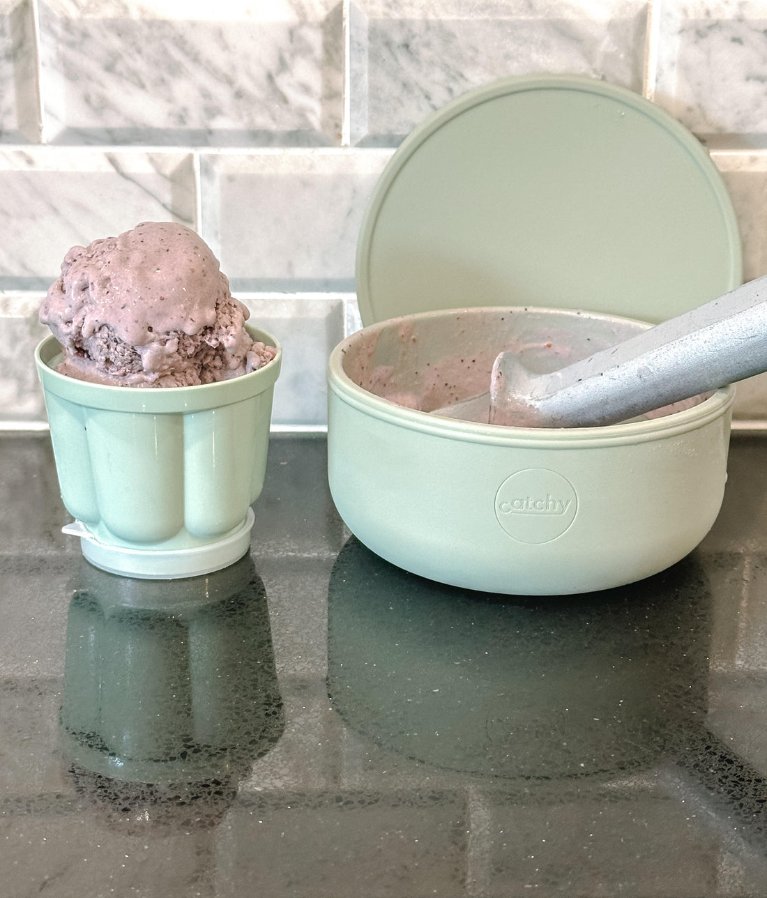 Mint green Catchy bowls with chocolate ice cream, ideal for mess-free mealtime on kitchen counter.