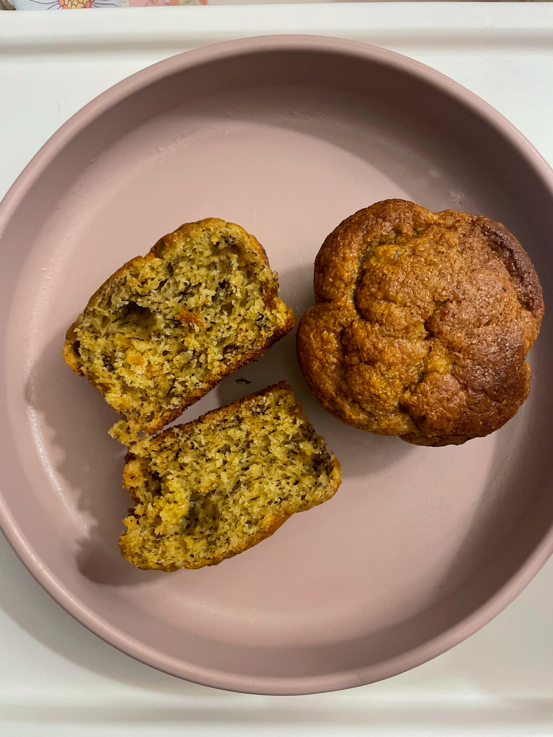 Fresh muffin sliced on pink plate, ideal for mess-free mealtime with easy cleanup